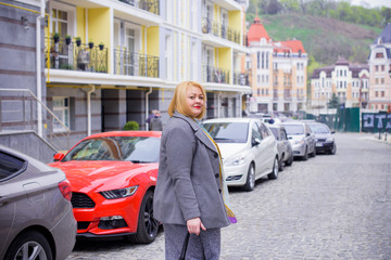 Fototapeta premium Happy smiling fashionable plus size young woman in modern city life. Life of xxl lady. Concept of positive lifestyle. Pretty stylish girl at city center 
