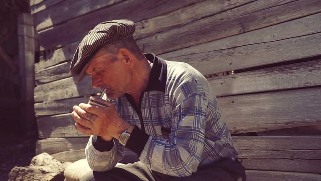 Farmer smoking a cigarette on the farm , straw cigarette