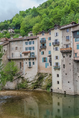 Fototapeta na wymiar Pont-en-Royans in the Vercors, typical colorful houses built on the cliff, over the river, in France 