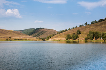 Landscape with clouds, mountain and lake