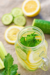 Glass of detox water with cucumber, lemon and celery