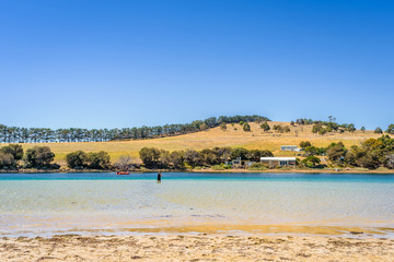 Cremorne Beach, South-Arm Peninsula, Tasmania, Australia: Relaxing quiet fishing day at a sandy beach river ocean coastline perfect sunny summer weather and blue water green mountains in background