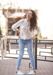 Happiness concept - happy woman having fun on city street during summer