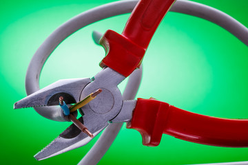 electric wires and tools on a green background