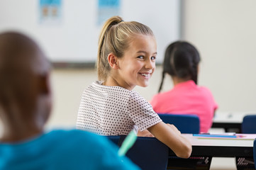 Pupil girl sitting in classroom