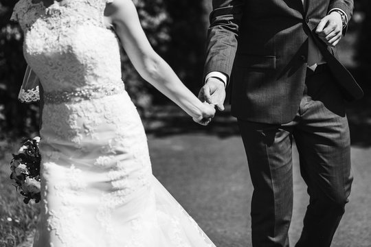 romantic touch. gorgeous bride and groom embracing and holding hands. black white photo. romantic moment. happy wedding couple