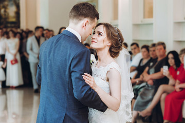 beautiful gorgeous bride and groom performing first dance. happy wedding couple dancing in...