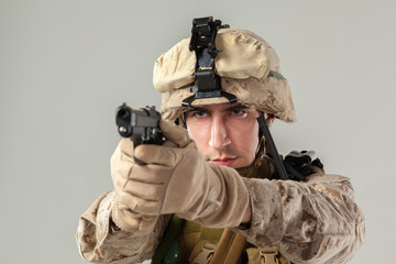 Soldier in camouflage holding rifle