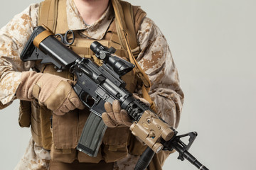 Fototapeta premium Soldier in camouflage holding rifle