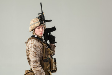 Soldier in camouflage holding rifle