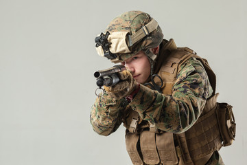 Soldier in camouflage holding rifle