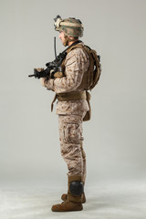 Soldier in camouflage holding rifle