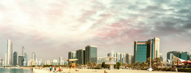 Abu Dhabi panoramic skyline at sunset as seen from Corniche Beach