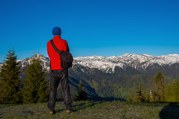 Fototapeta na wymiar Adventurer, photographer is standing on the mountain slope