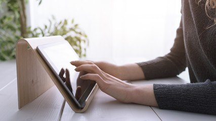 Woman using a digital tablet hands close up
