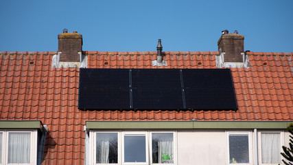 Black solar panels on the roof of a house