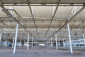 Abandoned industrial plant, interior. Spoiled and ruined industrial hall details, financial crisis, loss of employment.