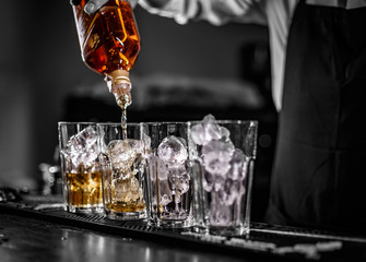 Barman pouring alcoholic drin