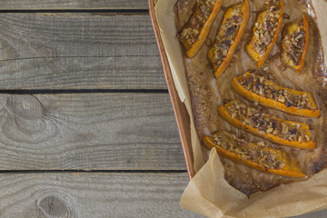 Authentic view of a pumpkin baked with slices of honey and walnuts