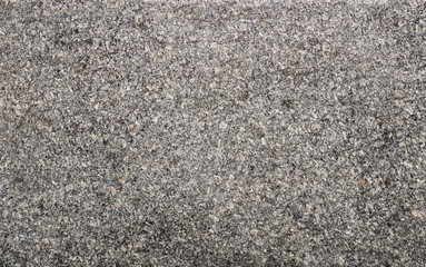 The texture of a stone fence made of granite. Background