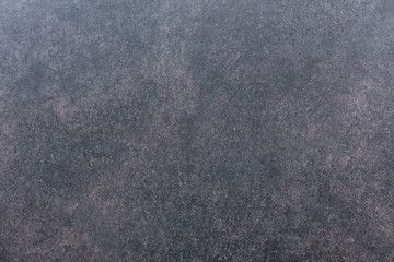 The texture of a wall of gray-red granite