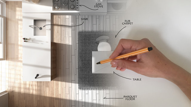 Top view, architect interior designer concept: hand drawing a design interior project and writing notes while the space becomes real, white and wooden modern kitchen
