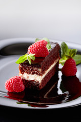 Chocolate cake with raspberry and mint .