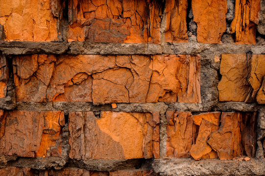 Cracked concrete vintage orange brick wall background