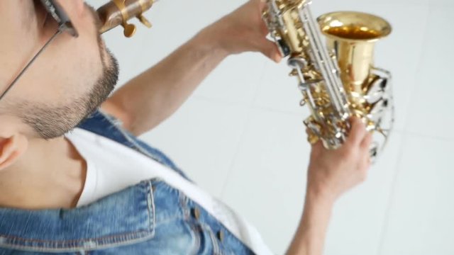 Man playing saxophone on white background