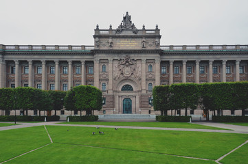 Fototapeta premium Building of The Parliament House of Sweden built in Neoclassical style, with a centered Baroque Revival style facade section in the Gamla stan, old town of Stockholm