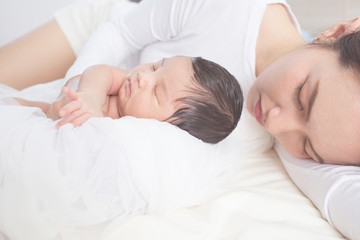 Fototapeta na wymiar happy mother with baby in bed