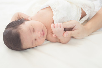 hand of a newborn baby in the hand of a parent dad