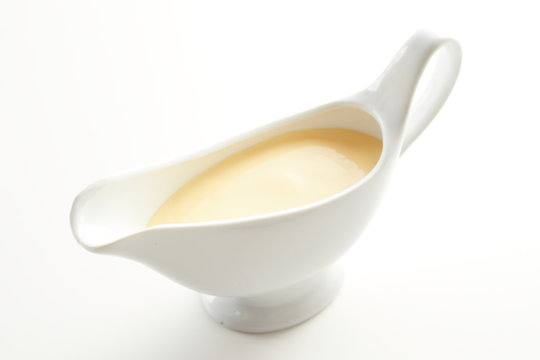 White ceramic sauce boat with Hollandaise sauce