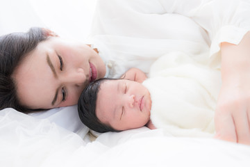 Fototapeta na wymiar happy mother with baby in bed