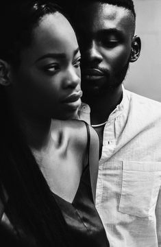 Lovely african newlyweds softly holding each other and smilling.