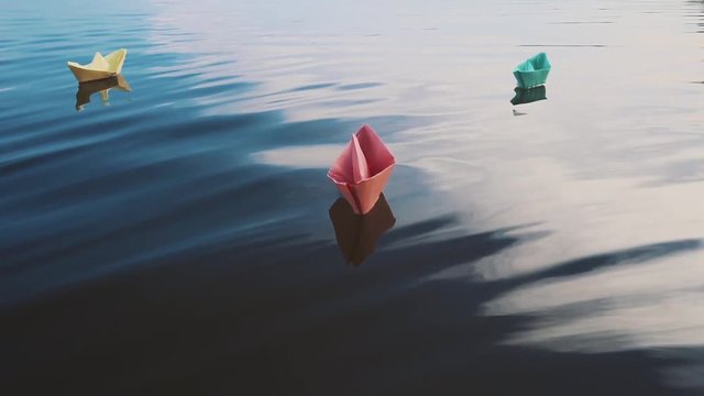 bluei paper sailboat sailing on water. River, lake, sea.