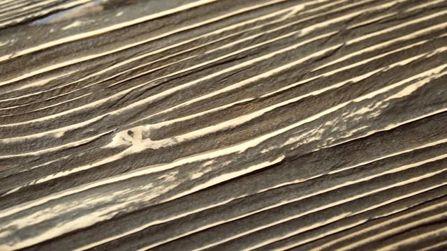 A sliding footage of a beautiful wooden surface texture. May be used for background.