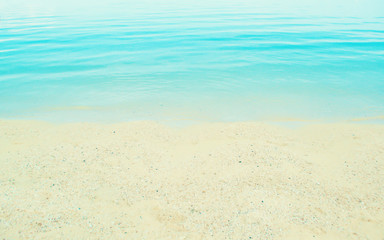 Fototapeta na wymiar soft focus blue sea and sand beach background