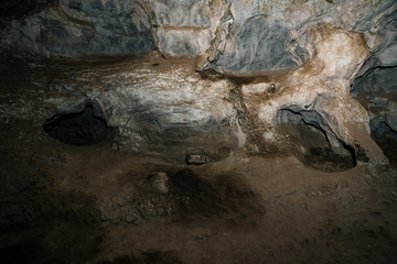Beautiful cave. View from inside dark dungeon. Textured walls of cave. Background image of underground. Dampness inside cave.