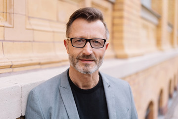 Street portrait of smiling bearded mature man