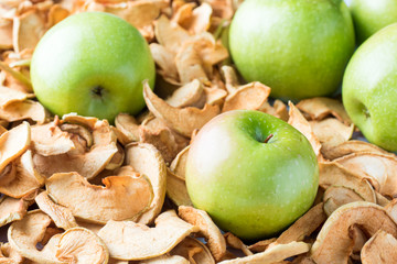 Background of sliced dried apples and ripe green apples