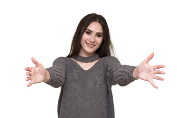 Beautiful brunette girl on white background arms wide apart.