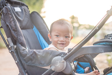 Baby in stroller and sunrise background