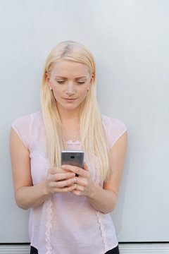 Portrait of blonde woman using mobile phone