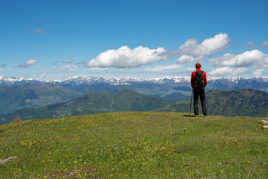 Hiker is relaxing on a green mountain meadow