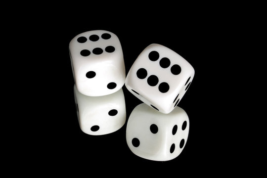 Pair of white dice on black reflective background