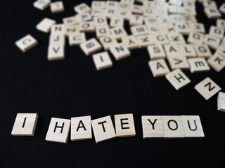 words hate text on wooden blocks on black background