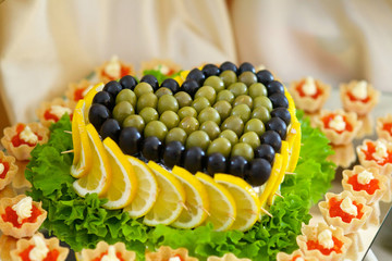 Salad garnished with lemons and olives.