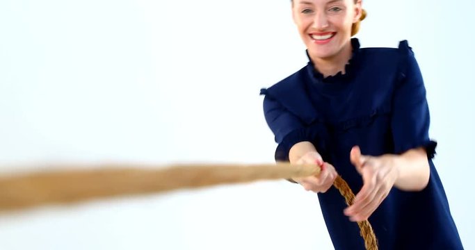 Woman pulling a rope against white background 