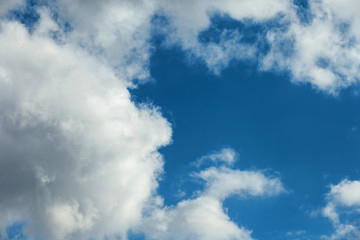 Naklejka na ściany i meble Background of transparent white clouds in a light blue sky